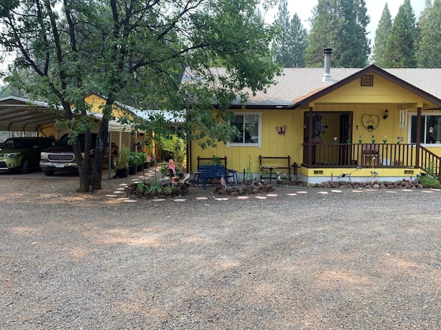 view of front facade featuring a porch and a carport