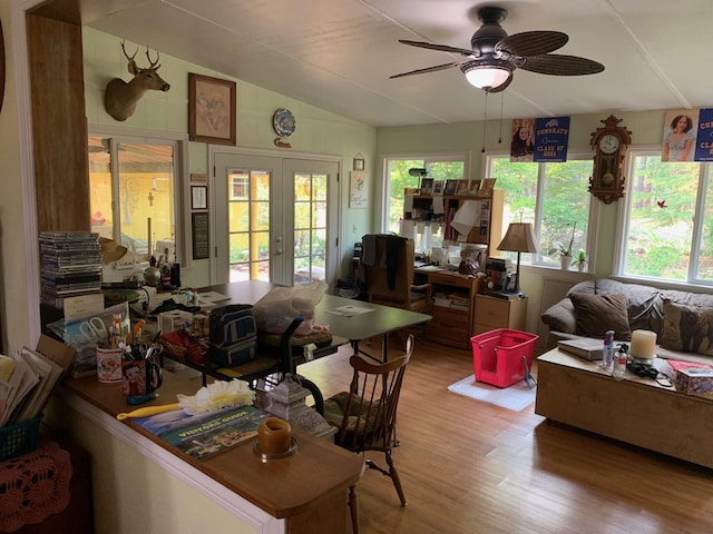 sunroom / solarium featuring ceiling fan, french doors, and lofted ceiling