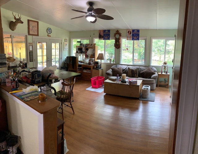 living room with lofted ceiling, french doors, ceiling fan, and wood-type flooring