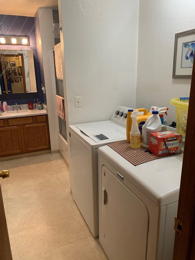 washroom with washer and dryer and sink