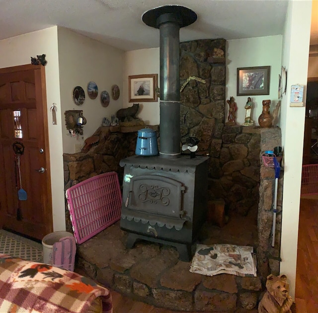 room details featuring a wood stove and hardwood / wood-style flooring