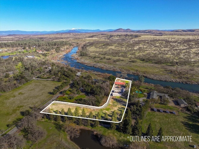 birds eye view of property featuring a water and mountain view