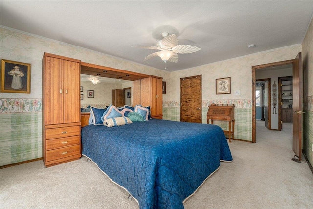 bedroom with ceiling fan, light carpet, and a textured ceiling