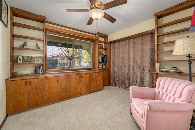 living area featuring light carpet, ceiling fan, and wooden walls