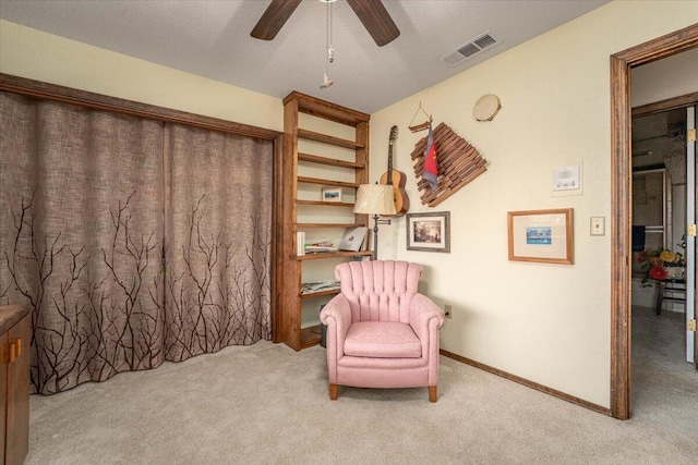 sitting room featuring ceiling fan and light colored carpet