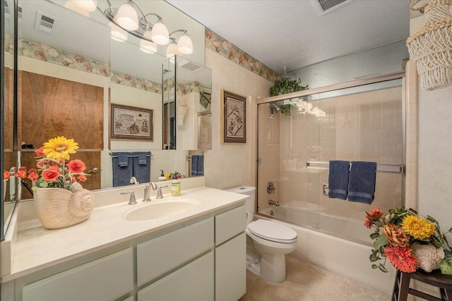 full bathroom featuring toilet, vanity, and shower / bath combination with glass door