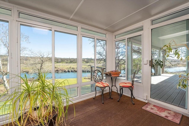 sunroom / solarium with a water view