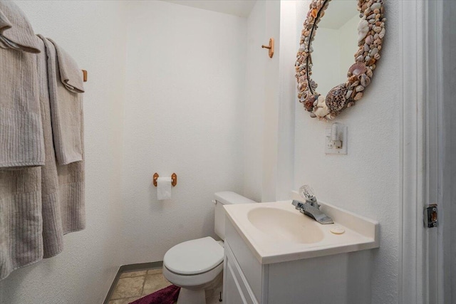 bathroom featuring tile patterned floors, toilet, and vanity