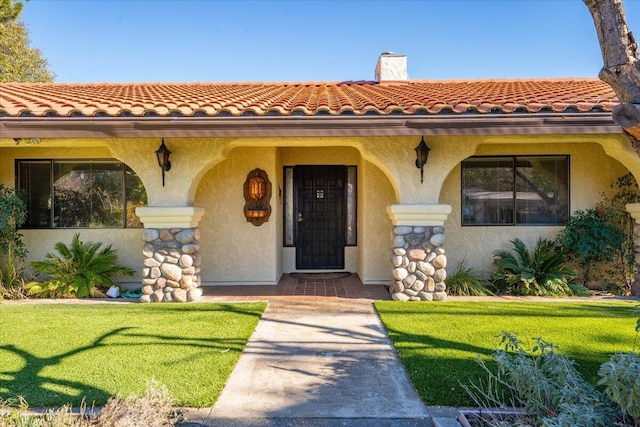 entrance to property with a yard