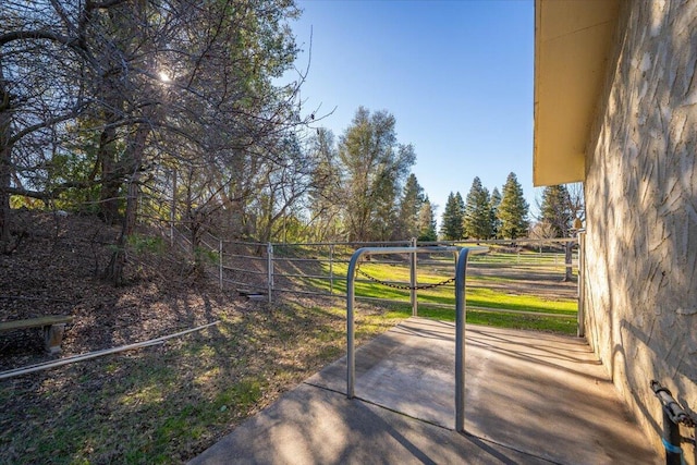 view of gate with a patio