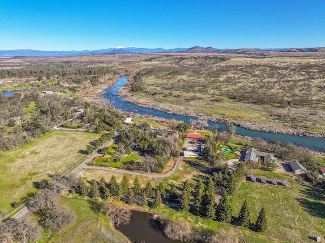 drone / aerial view with a water and mountain view