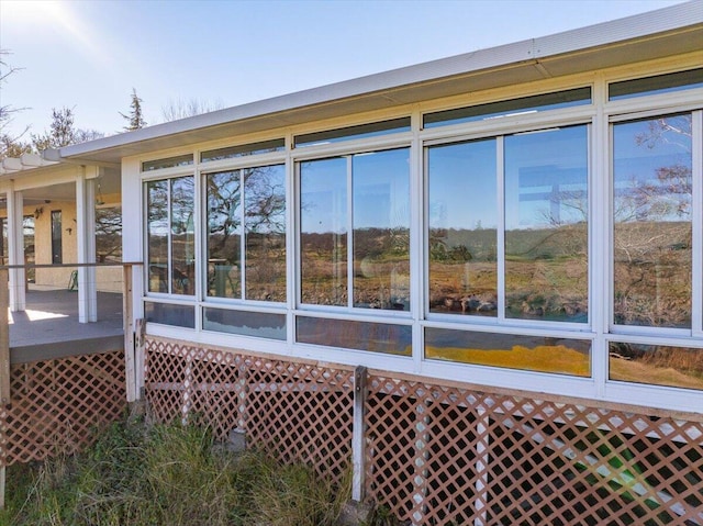 view of property exterior with a sunroom