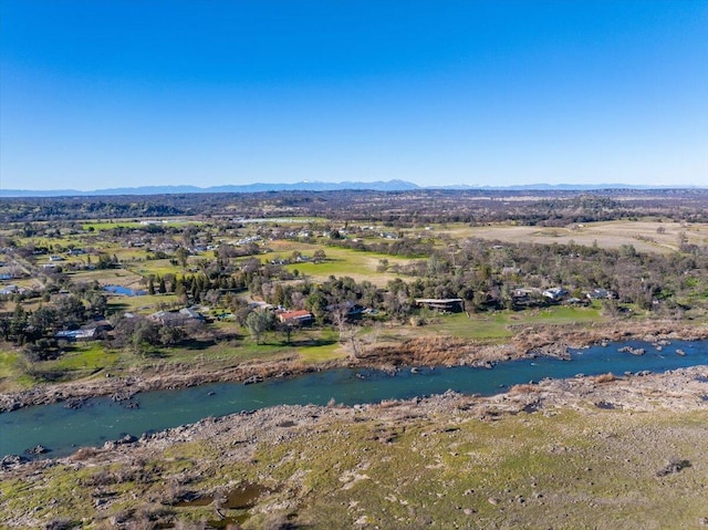 birds eye view of property with a water and mountain view