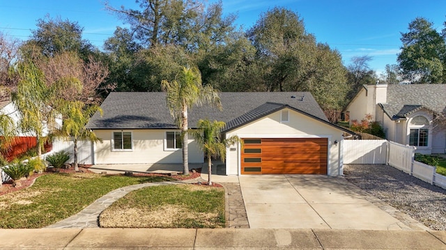 view of front of house featuring a garage and a front yard