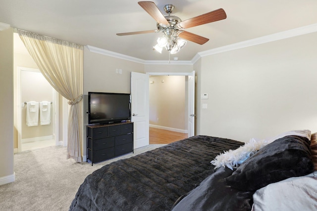 bedroom with ceiling fan, ensuite bath, ornamental molding, and light carpet