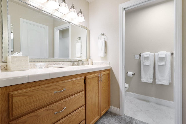 bathroom with tile patterned floors, vanity, and toilet