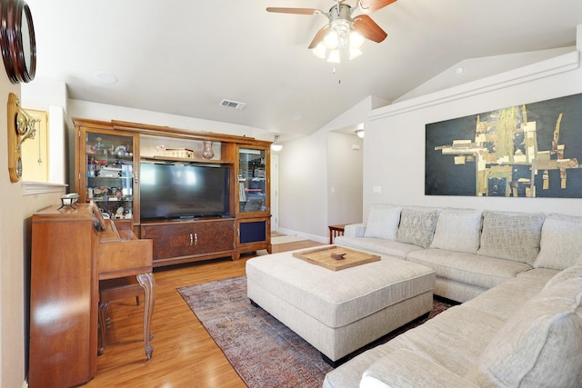 living room featuring lofted ceiling, hardwood / wood-style flooring, and ceiling fan