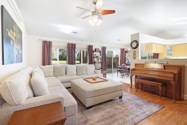 living room featuring ceiling fan, a wealth of natural light, lofted ceiling, and hardwood / wood-style flooring