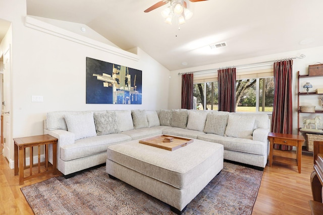 living room with lofted ceiling, ceiling fan, and hardwood / wood-style floors