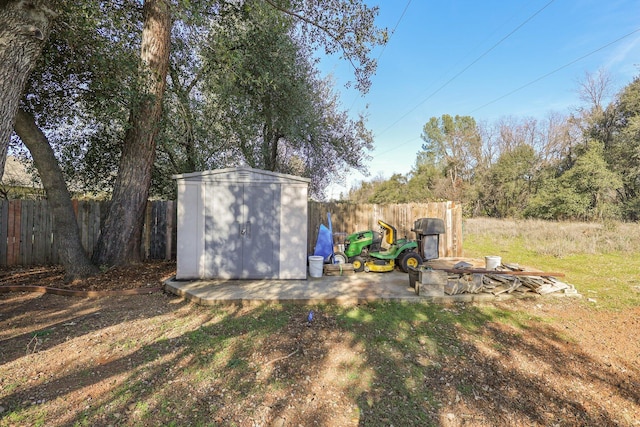 view of yard featuring a patio area and a storage shed