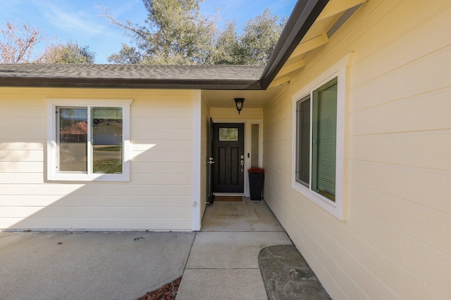 view of exterior entry featuring a patio