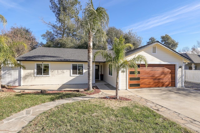 single story home with a front yard and a garage