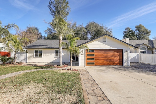 ranch-style house with a front yard and a garage