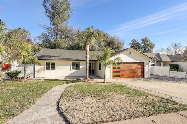 ranch-style house featuring a front yard and a garage