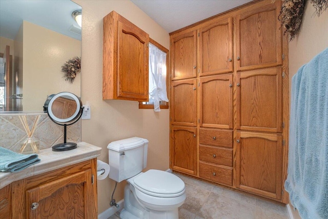 bathroom featuring toilet and vanity