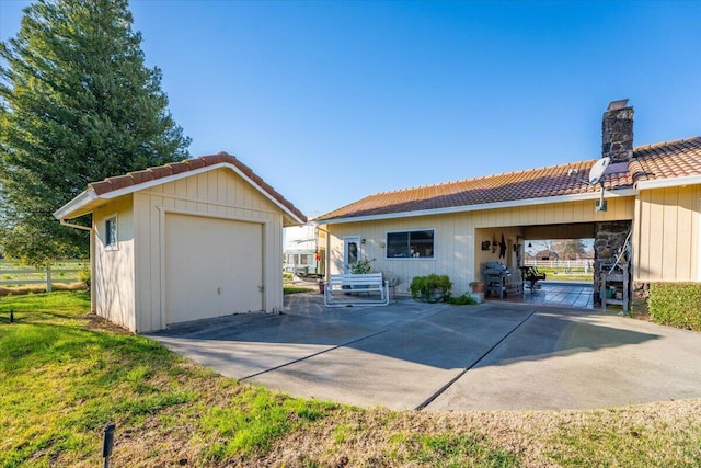 back of house featuring an outbuilding and a garage