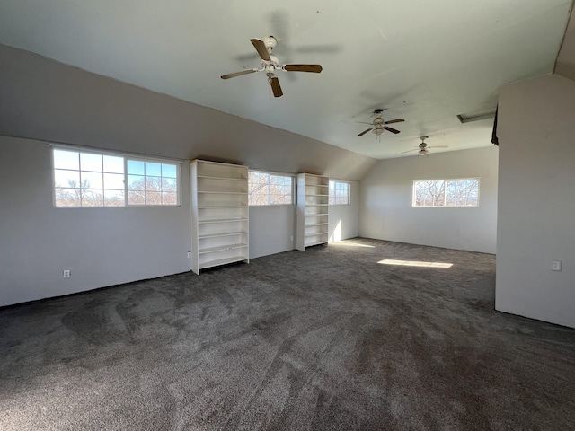 unfurnished living room featuring lofted ceiling and dark colored carpet