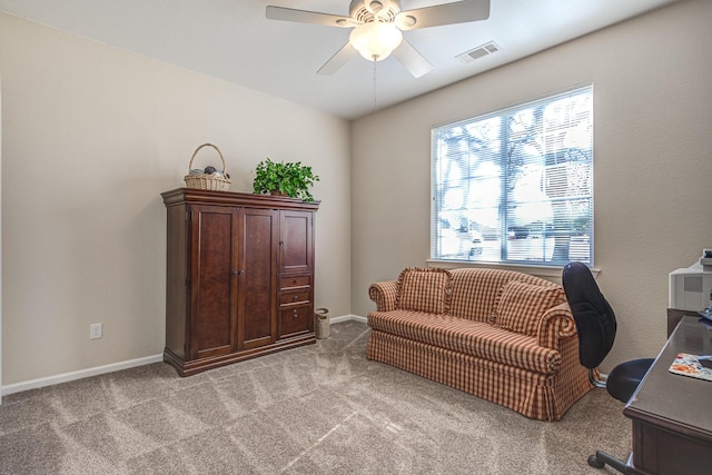 carpeted office space with ceiling fan