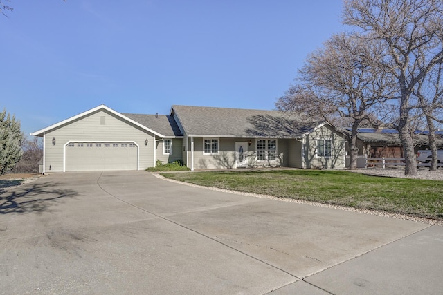 ranch-style house featuring a garage and a front yard