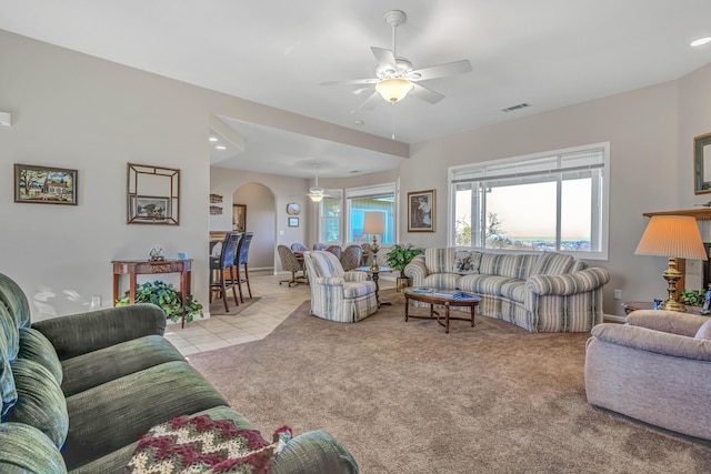 carpeted living room featuring ceiling fan