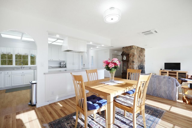 dining space featuring sink and light wood-type flooring