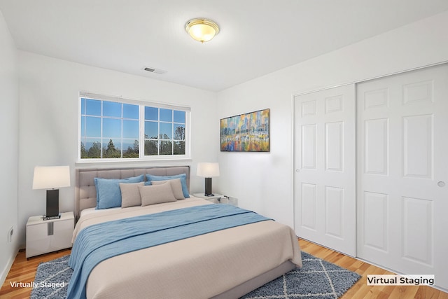 bedroom featuring hardwood / wood-style floors and a closet