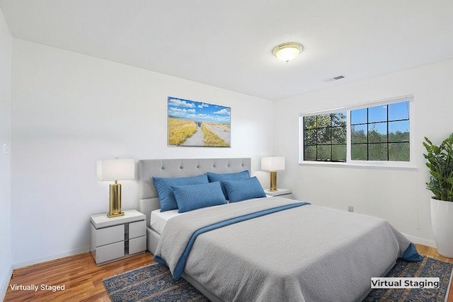 bedroom with hardwood / wood-style flooring