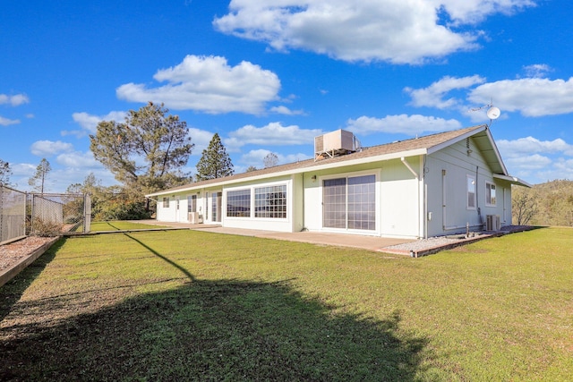 back of property with central AC, a yard, and a patio