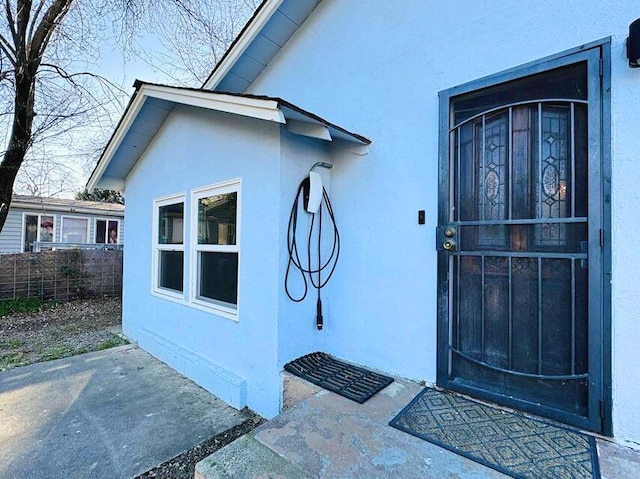 entrance to property featuring a patio