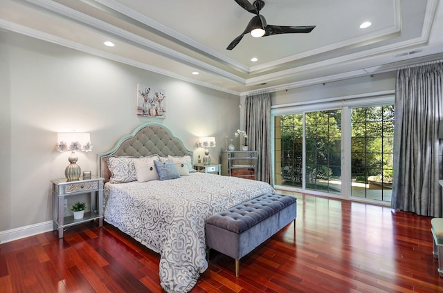 bedroom with ceiling fan, hardwood / wood-style floors, a tray ceiling, and crown molding