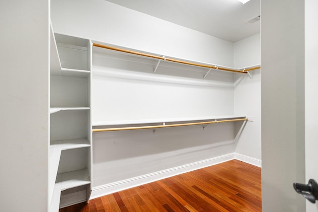 walk in closet with hardwood / wood-style floors