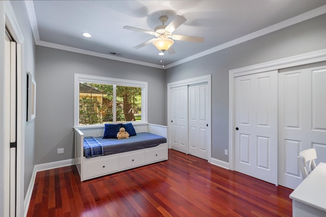 living area with ceiling fan, ornamental molding, and dark hardwood / wood-style floors