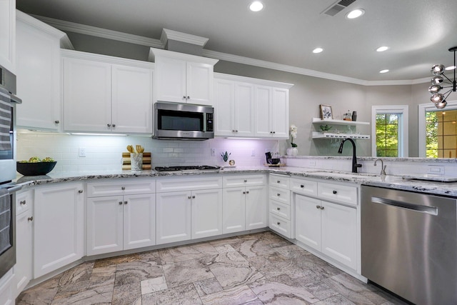 kitchen with sink, white cabinets, appliances with stainless steel finishes, and tasteful backsplash