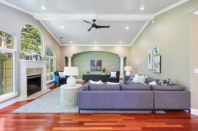 living room featuring ceiling fan, vaulted ceiling with beams, ornate columns, and hardwood / wood-style flooring