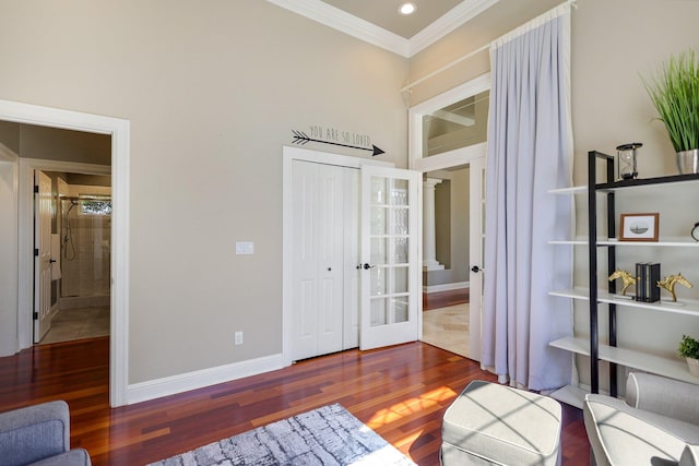 living area with french doors, ornamental molding, and hardwood / wood-style flooring