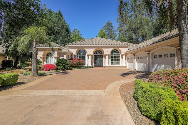 mediterranean / spanish-style home featuring a garage