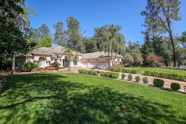 view of front of property with a garage and a front yard