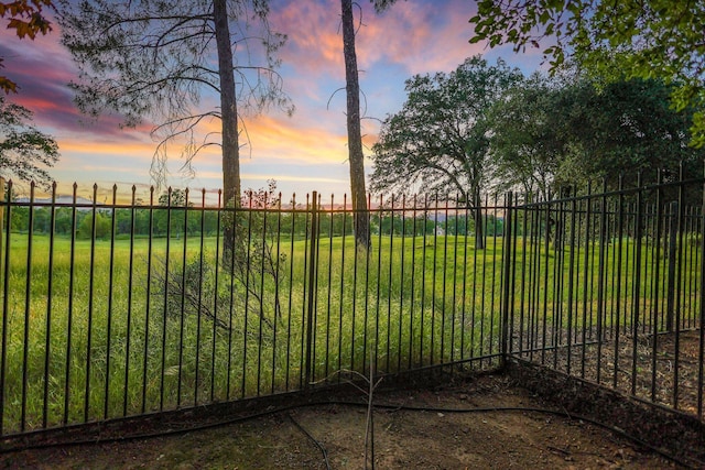 gate at dusk with a lawn