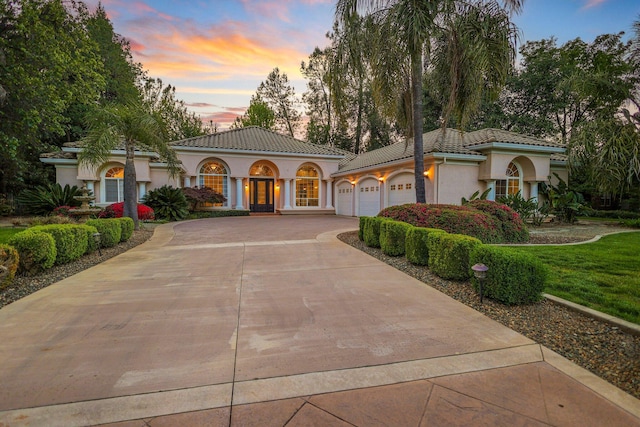 mediterranean / spanish house with a garage