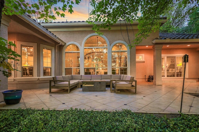 patio terrace at dusk featuring an outdoor hangout area